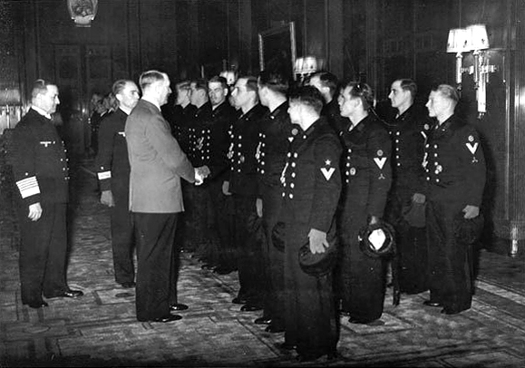 Adolf Hitler receives and awards Günther Prien and the crew of the U-47 submarine who sank the British battleship HMS Royal Oak anchored in Scapa Flow